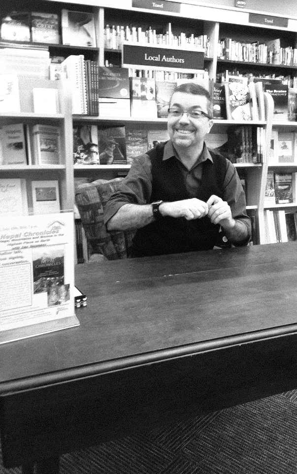 The author sitting at a bookstore table